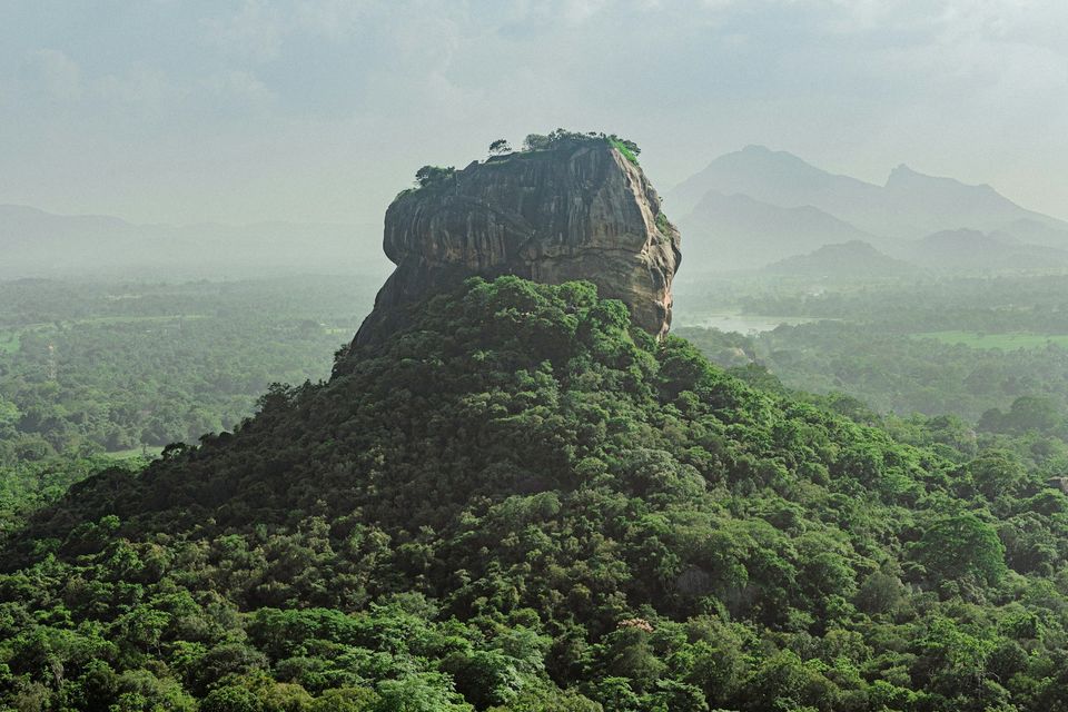 Sigiriya rising from misty forest in Sri Lanka